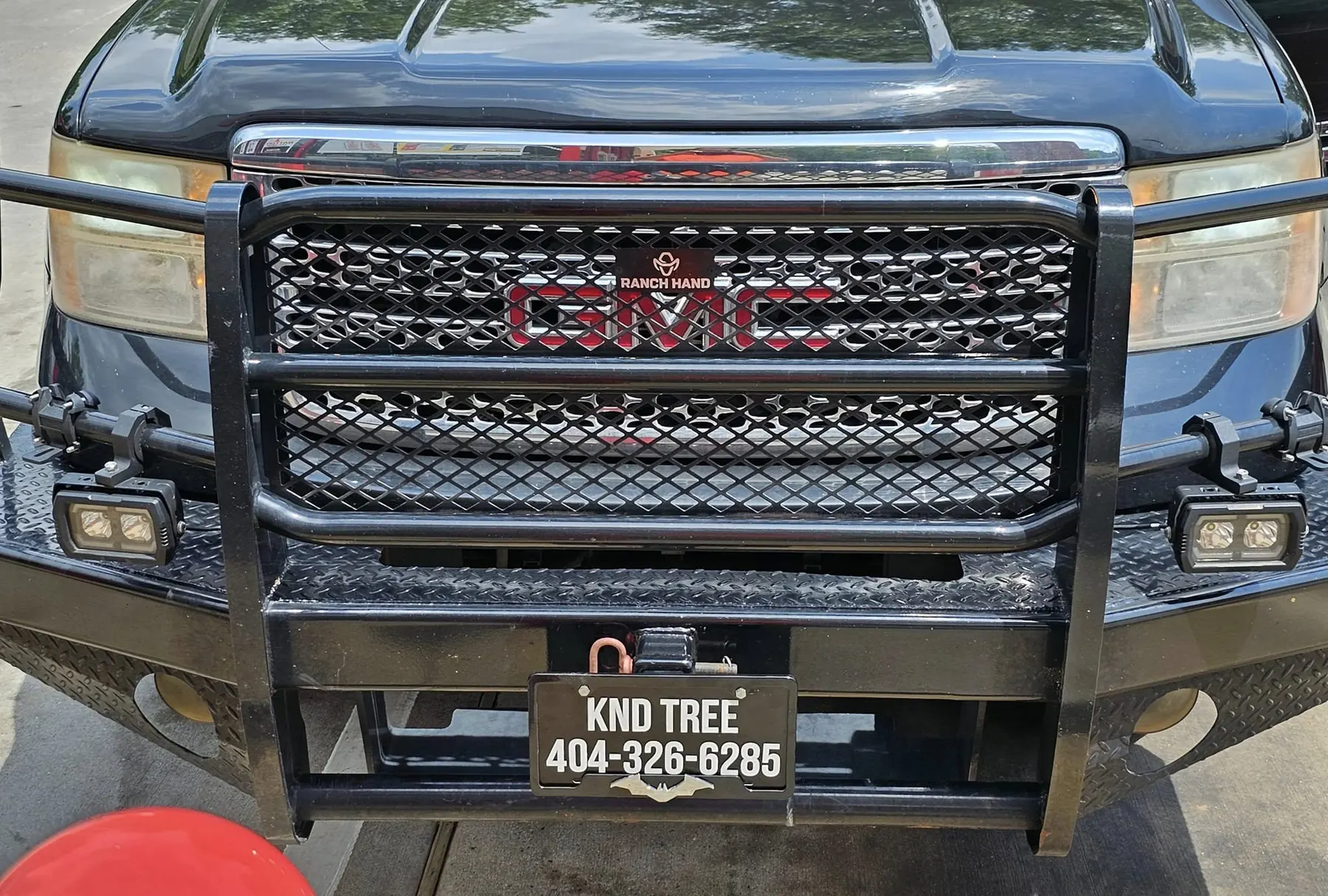 Front of the KND Tree Service truck showing the company phone number